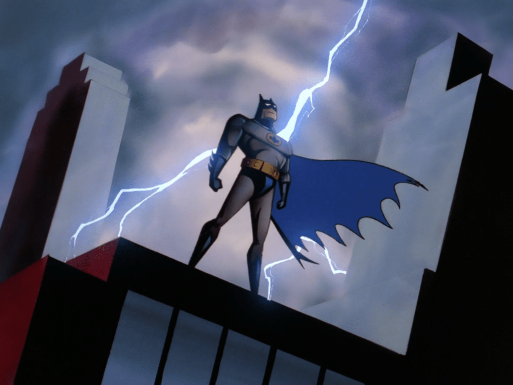 Batmand standing on a rooftop looking down at the city with a flash of lightning in the sky behind him. From the opening title sequence of Batman the Animated Series